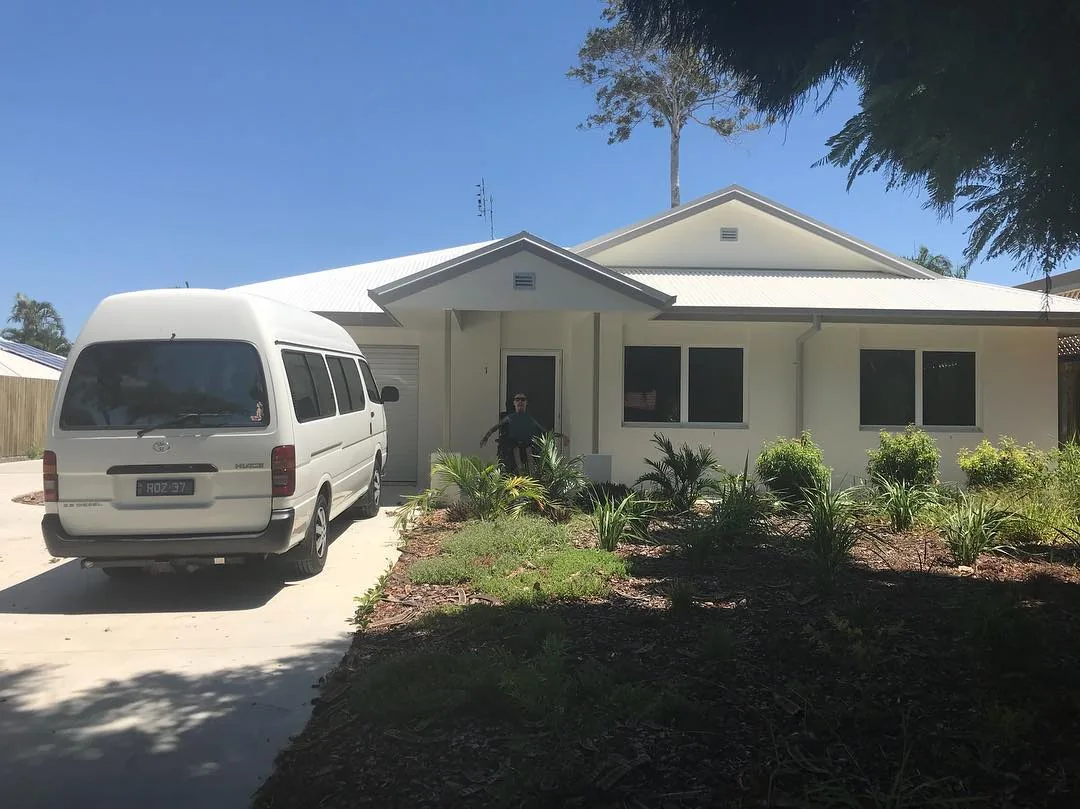 A single-storey home with a white van parked outside