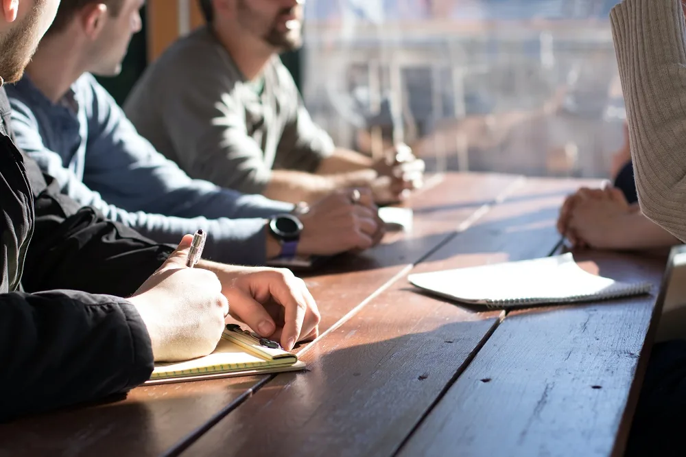 People discussing documents around a table