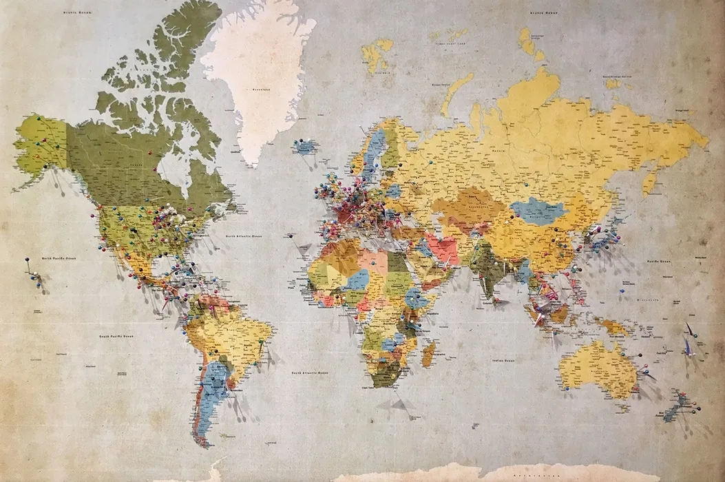 A colourful world map displayed on a wall