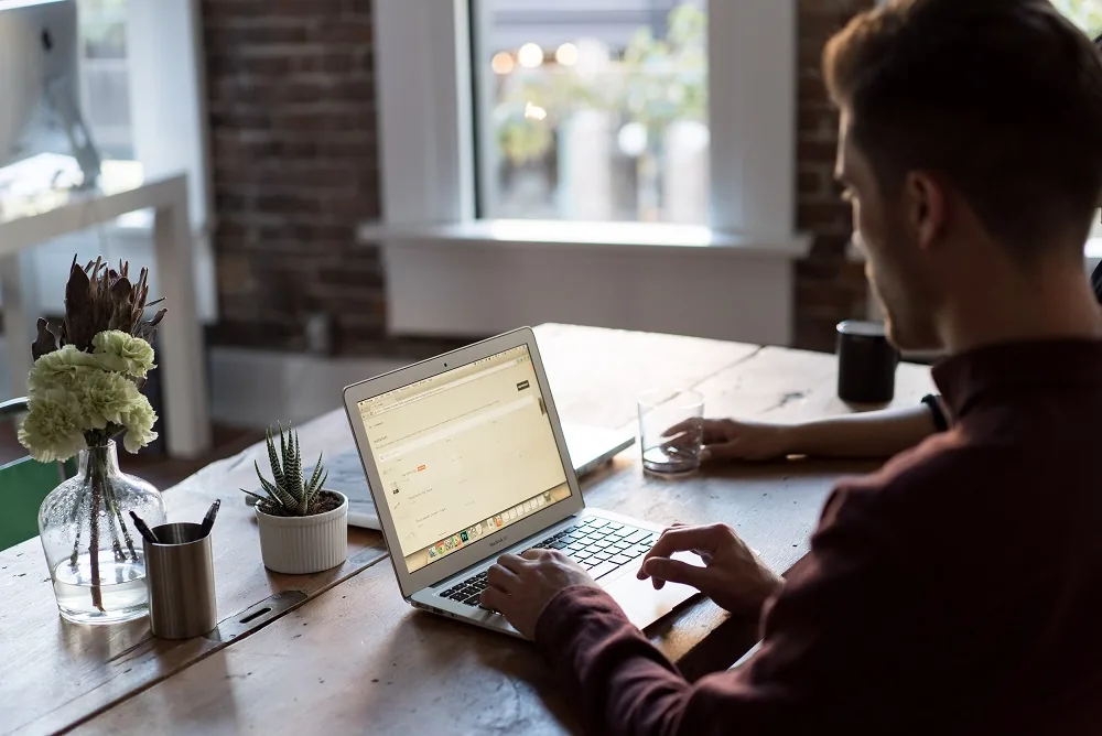 A person working at a desk with a laptop