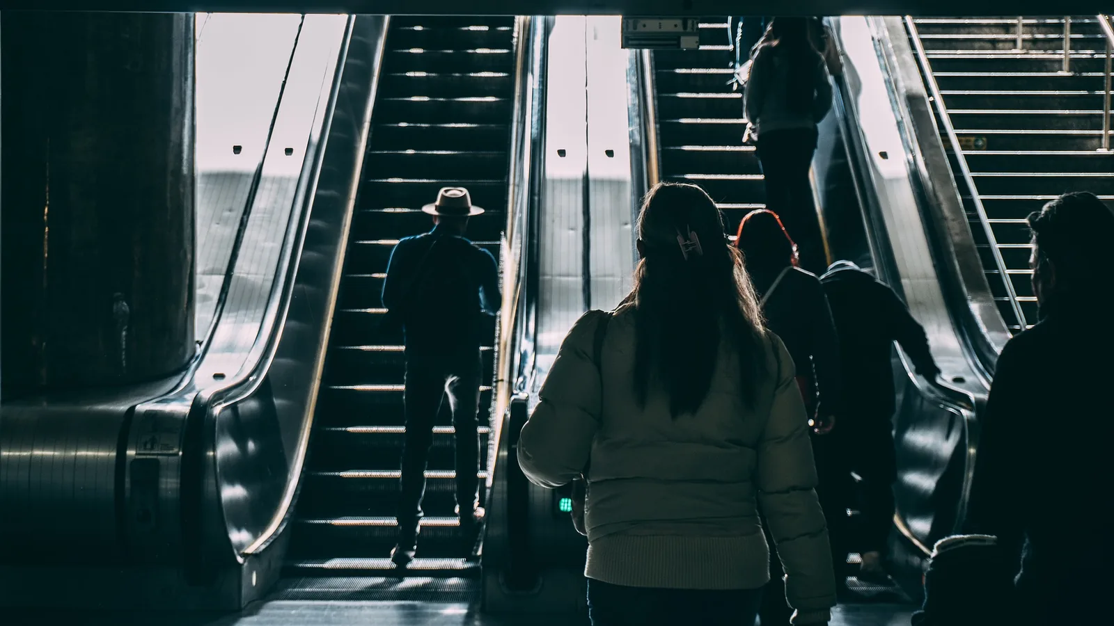 A person in front of escalators in a public building