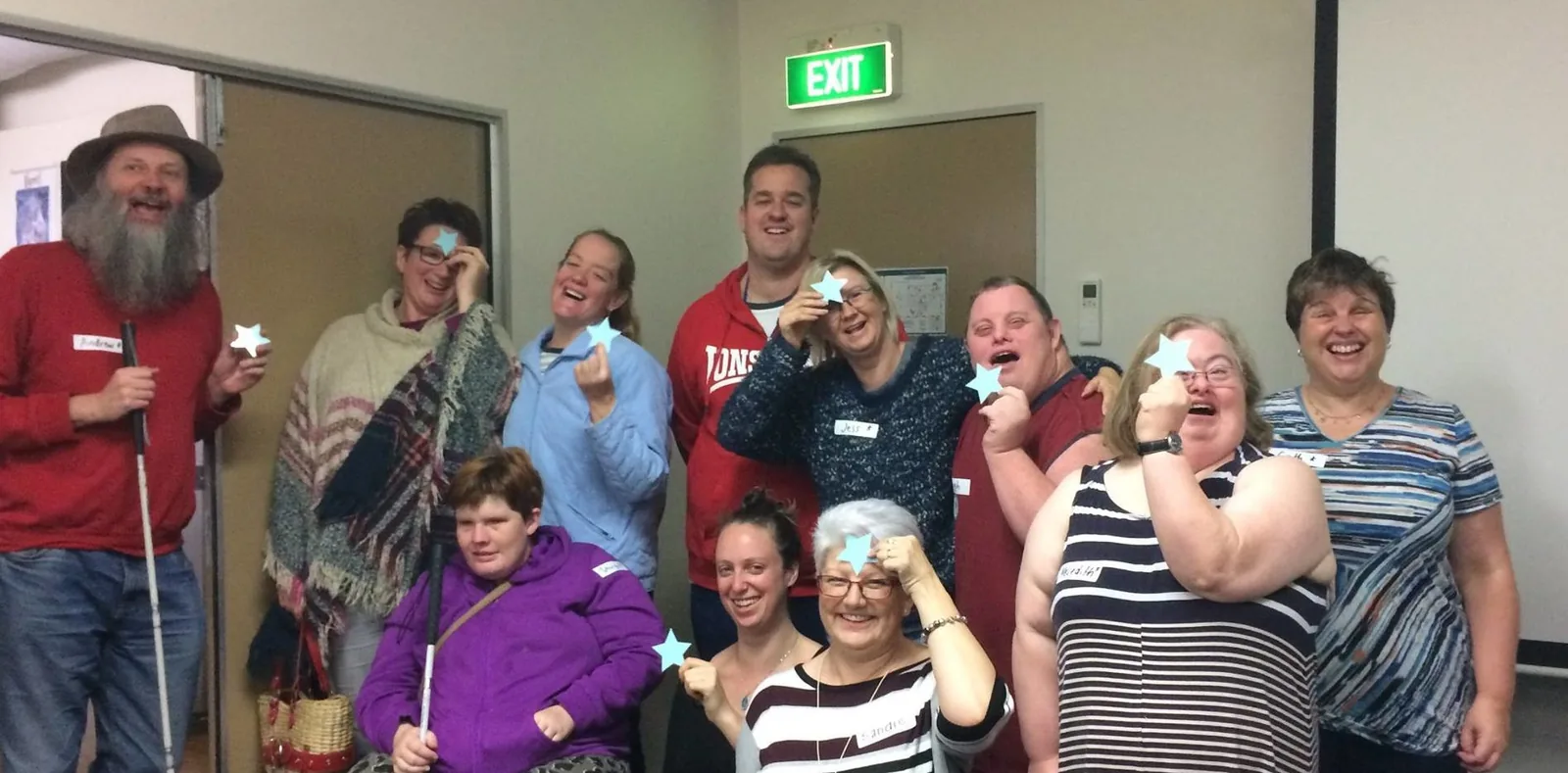 A group posing together indoors in the original feedback-workshop article