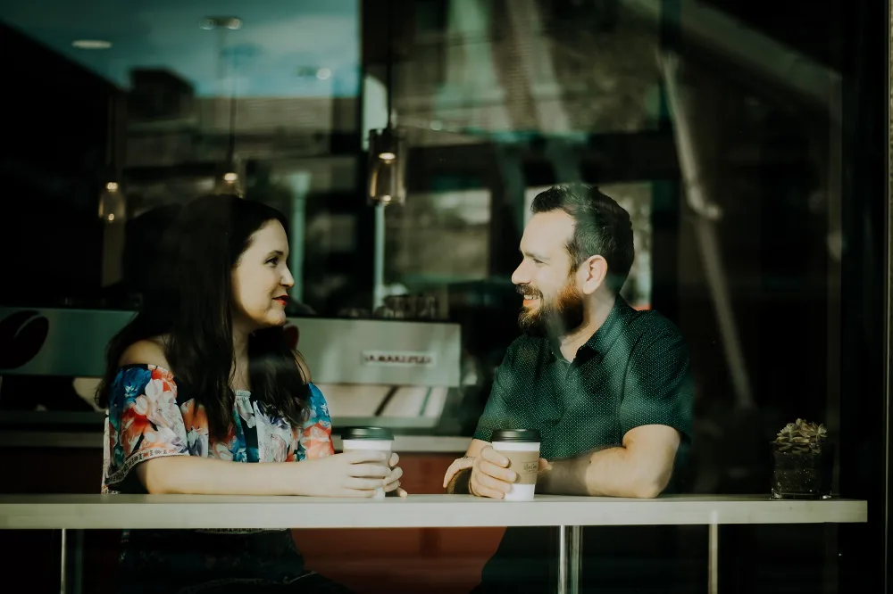 Two people talking across a table