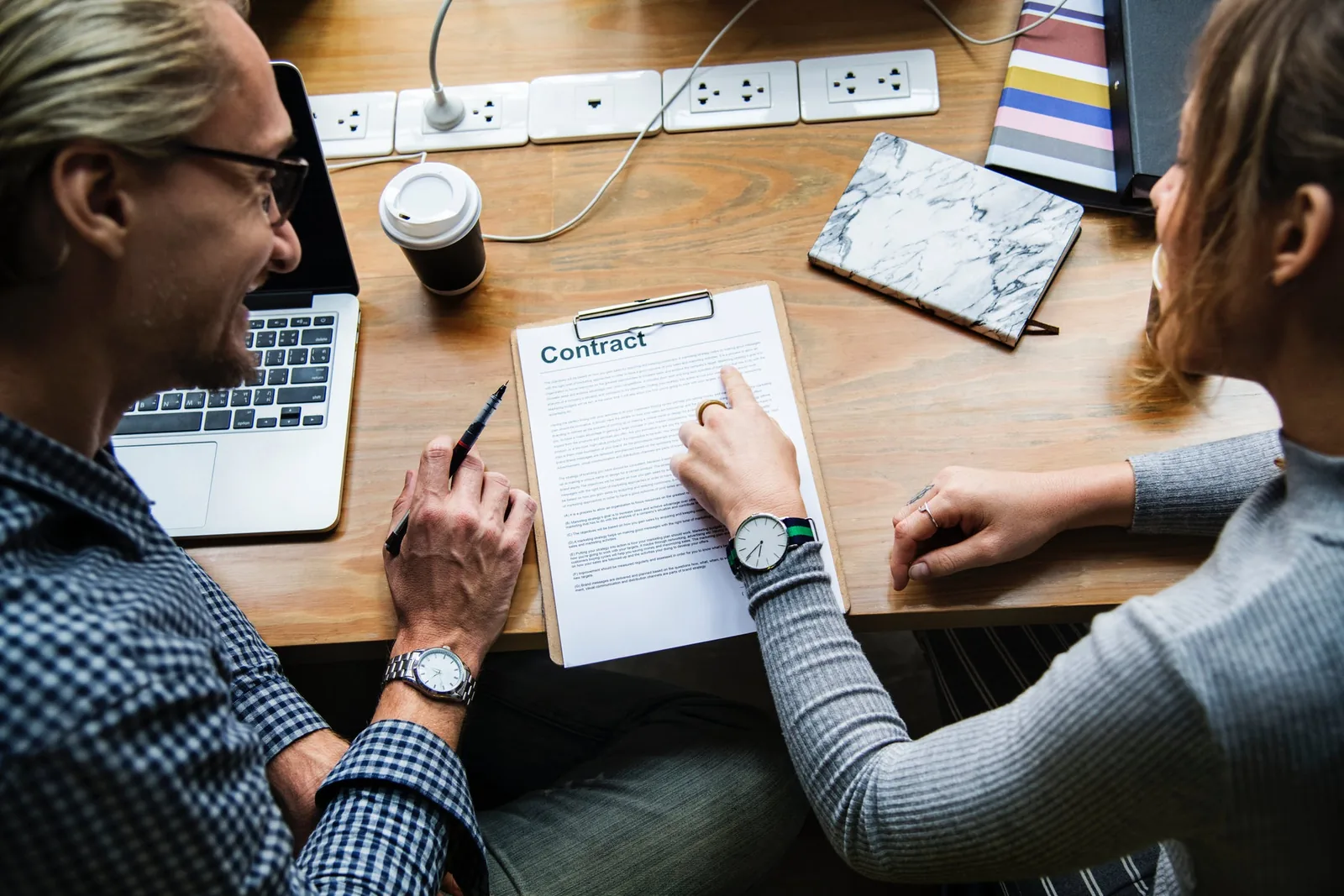 Two people reviewing paperwork at a desk