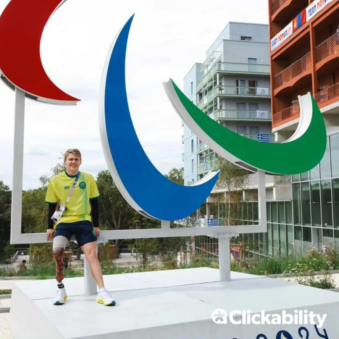 A man standing in front of the Paralympic statue in Paris. 