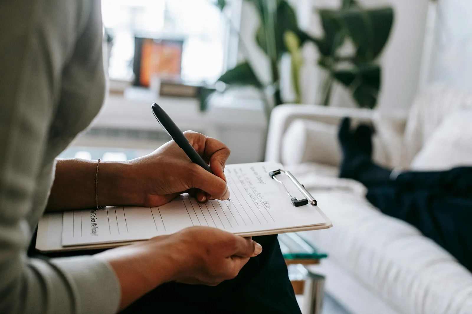 A person taking notes during a conversation