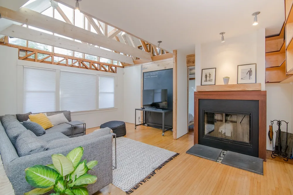 A furnished living room with a sofa and fireplace