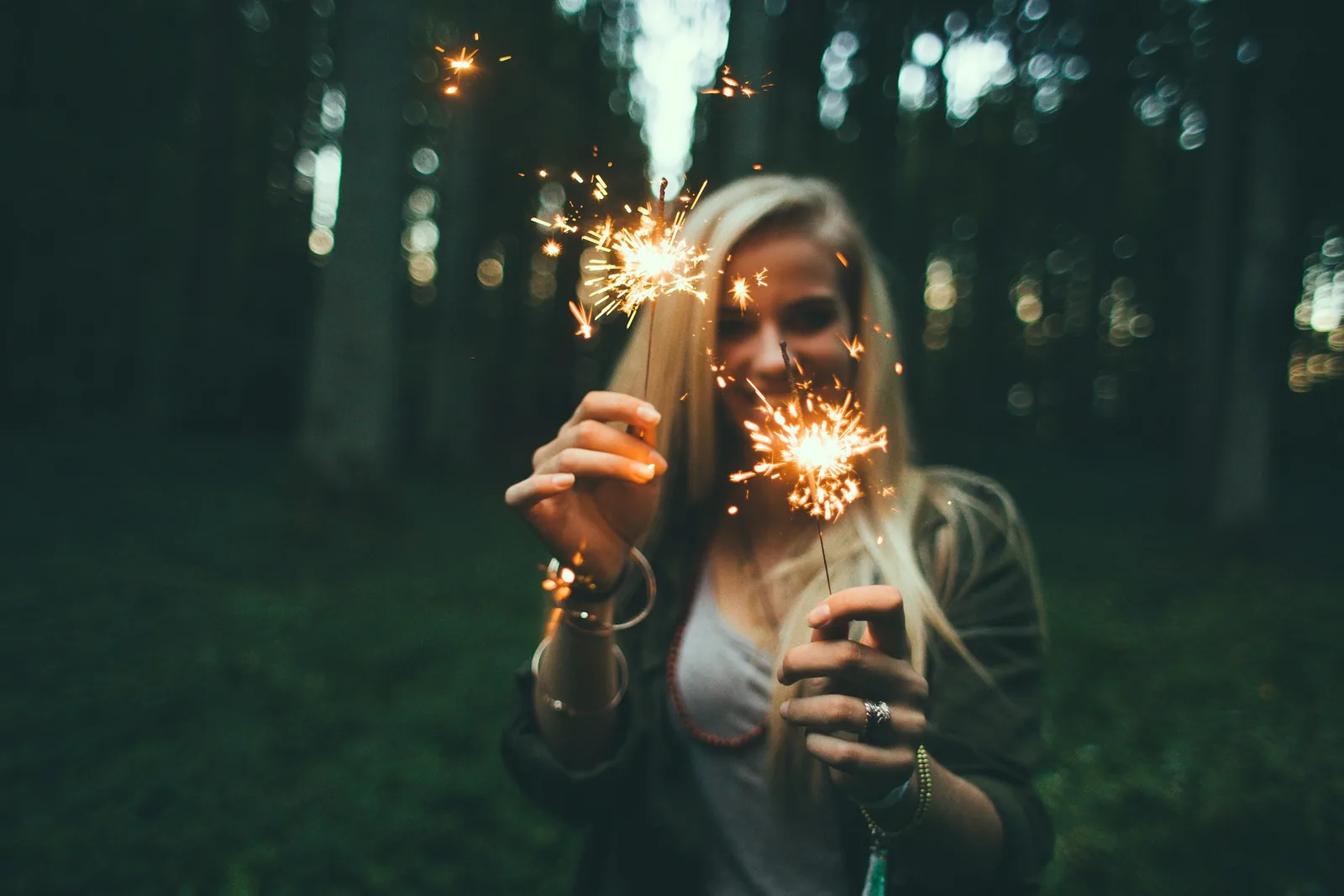 A person holding a sparkler outdoors
