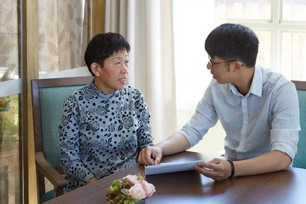 Two people discussing a document at a table