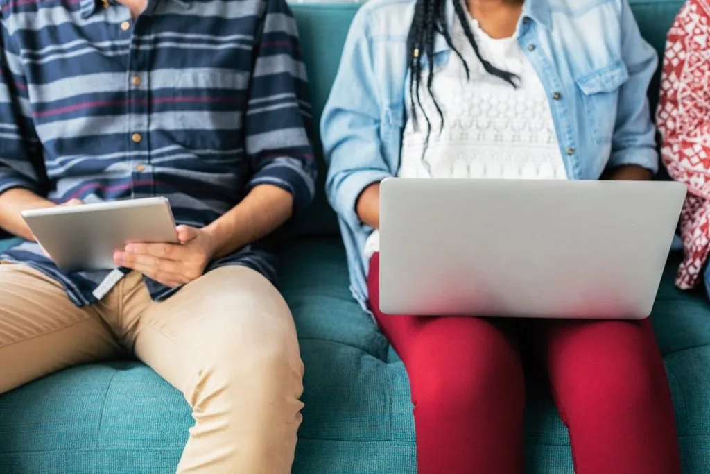 Two people on tablets/laptops