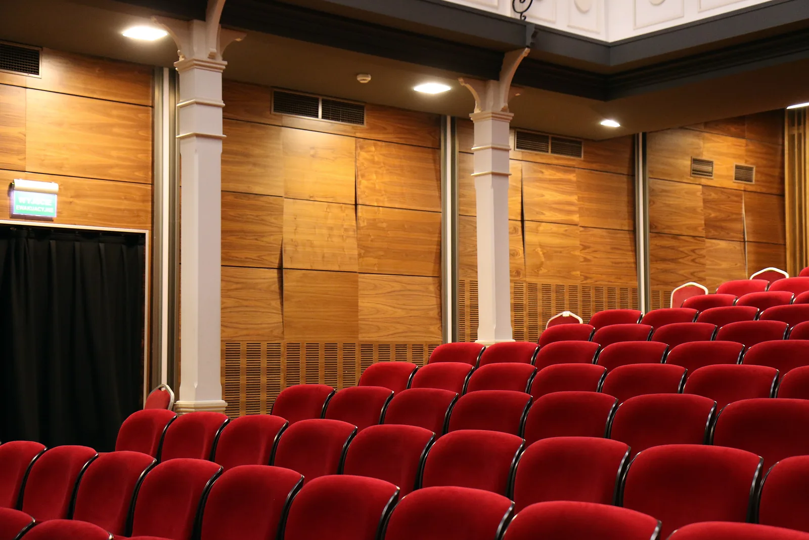 Rows of red seats in an empty theatre
