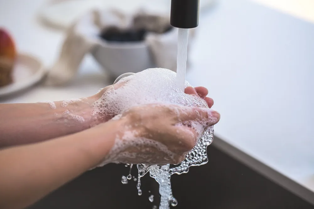 Hands being washed under running water