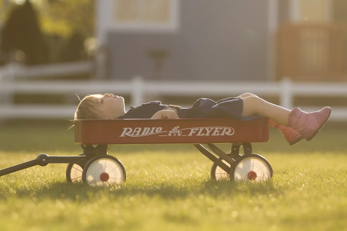 Kid relaxing in a cart under afternoon sun