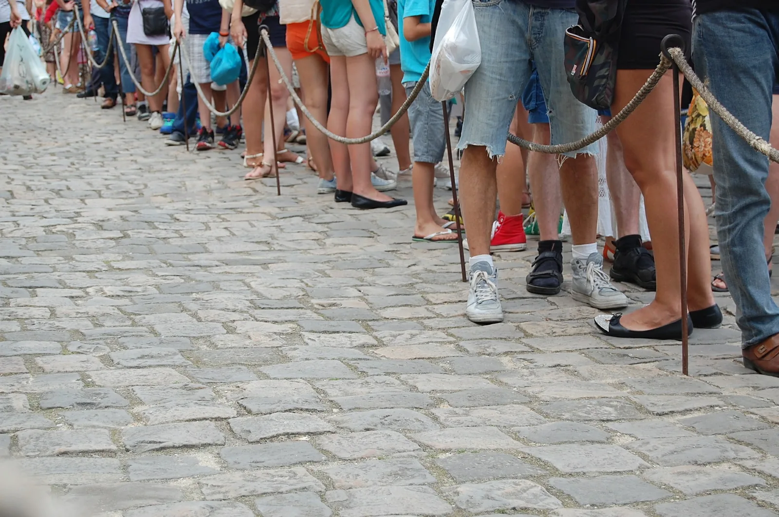 A queue of people on a city pavement