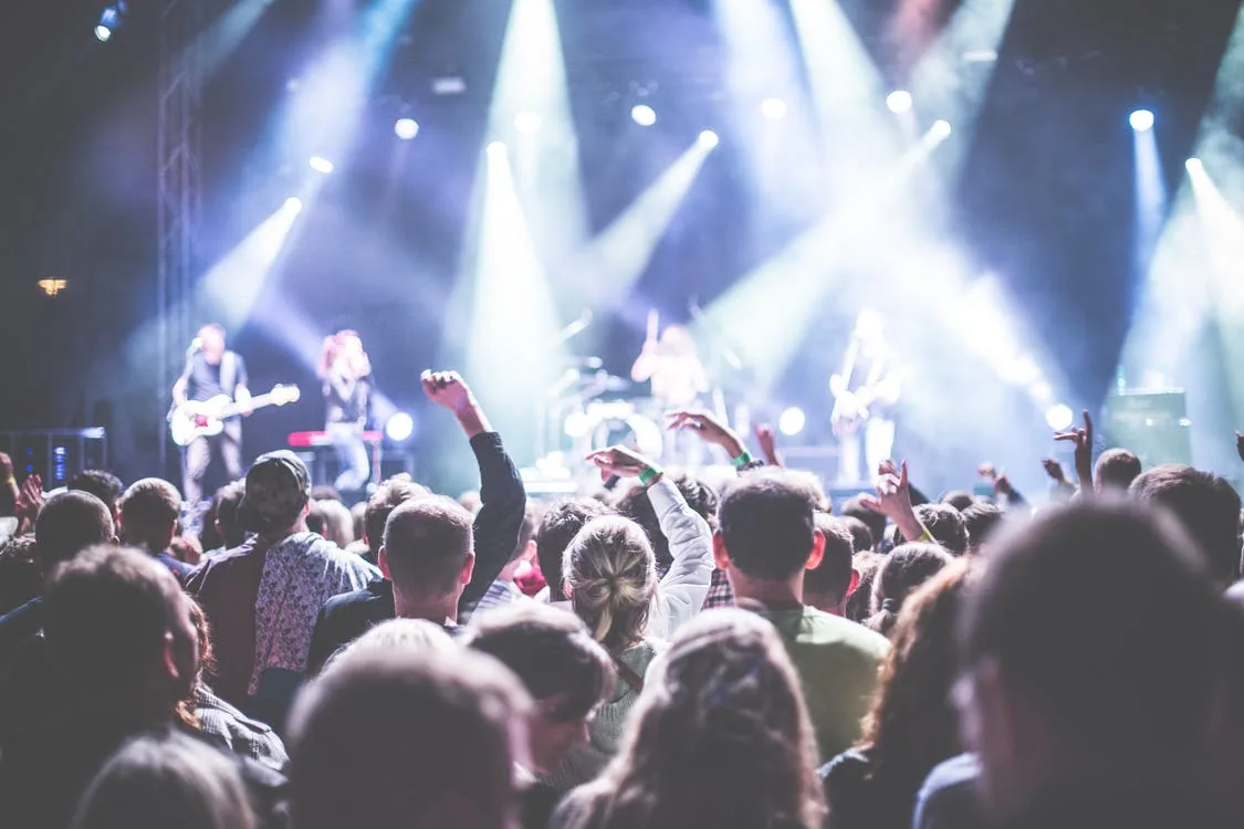 Audience members watching a band perform on a stage
