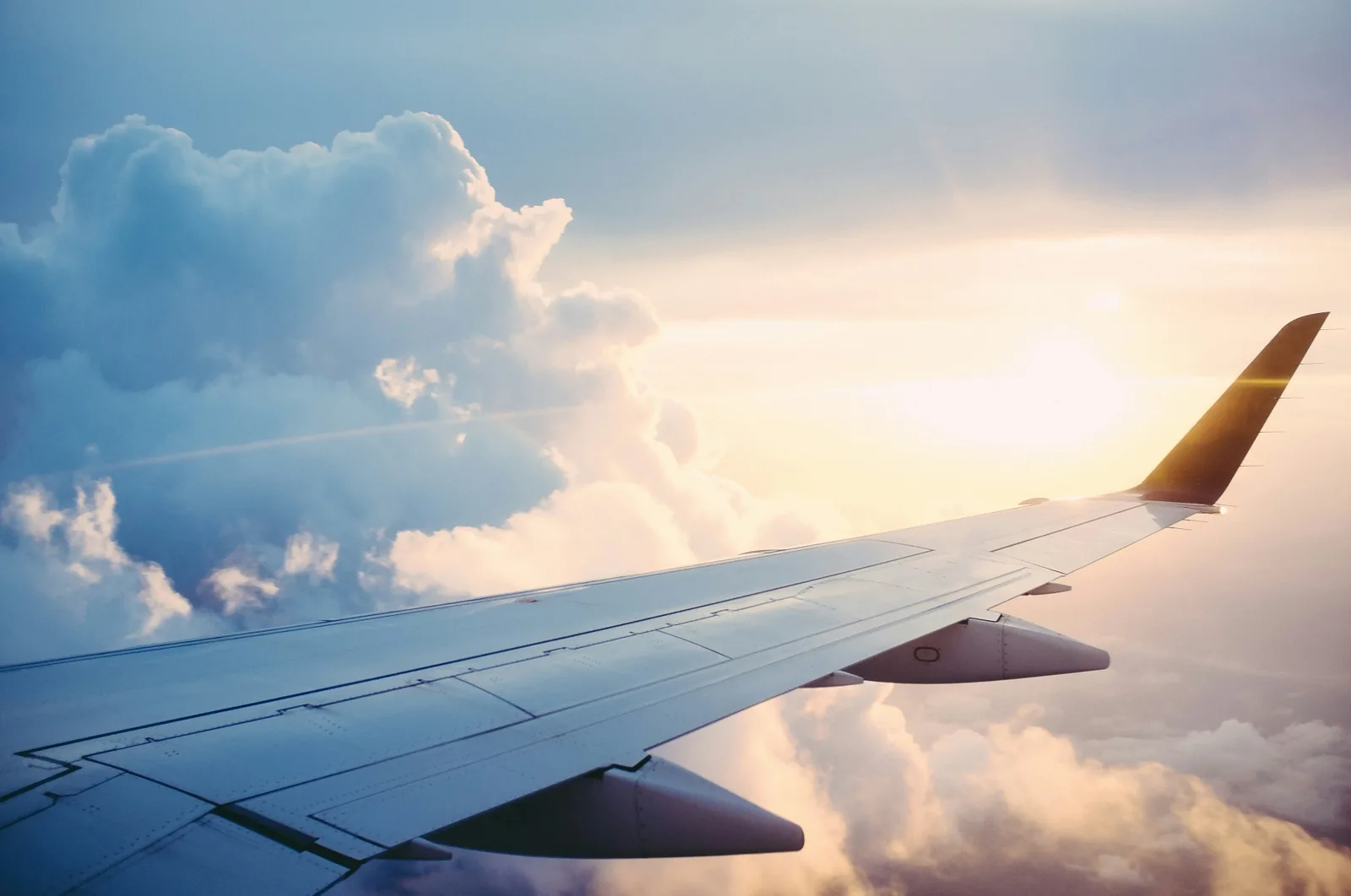 An aircraft wing above clouds