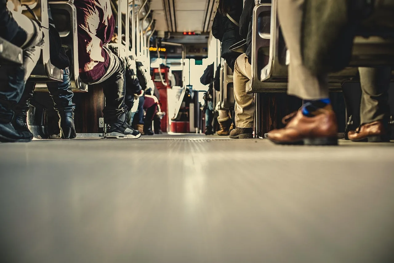 View of people’s lower legs on public transport