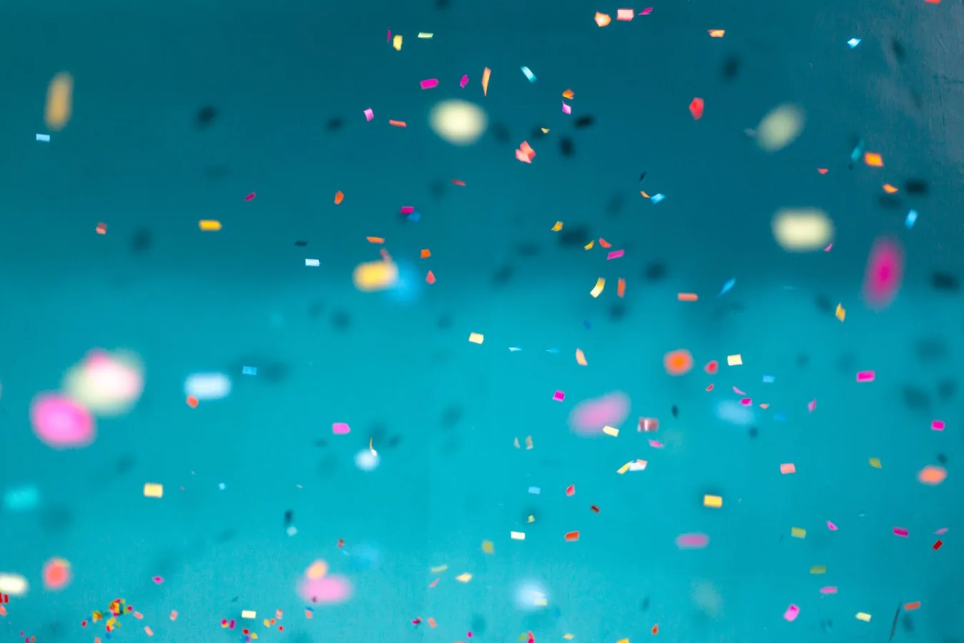 Colourful confetti against a blue background