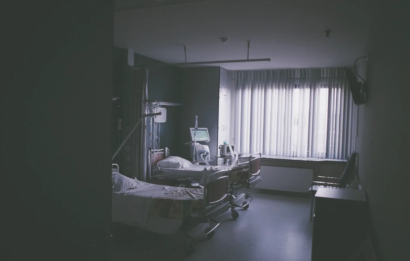 A hospital room with beds and medical equipment