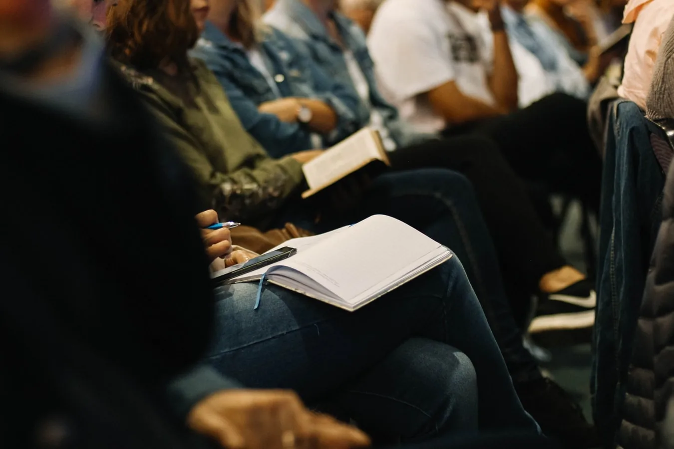 People seated together with notebooks