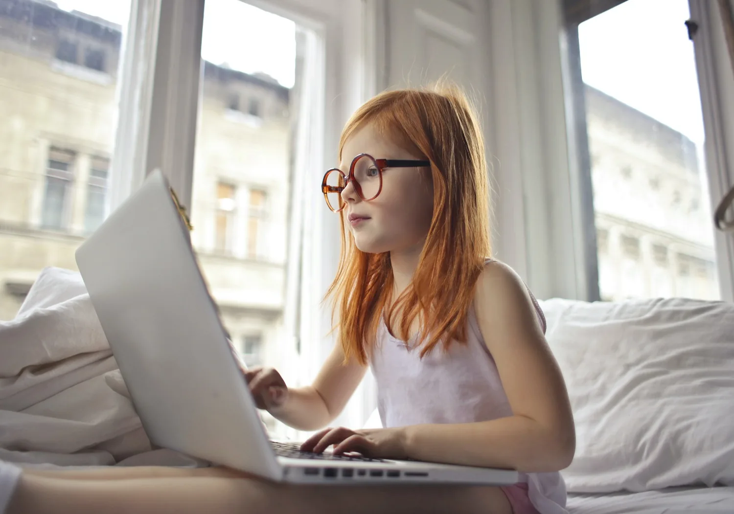 A person using a laptop on a sofa