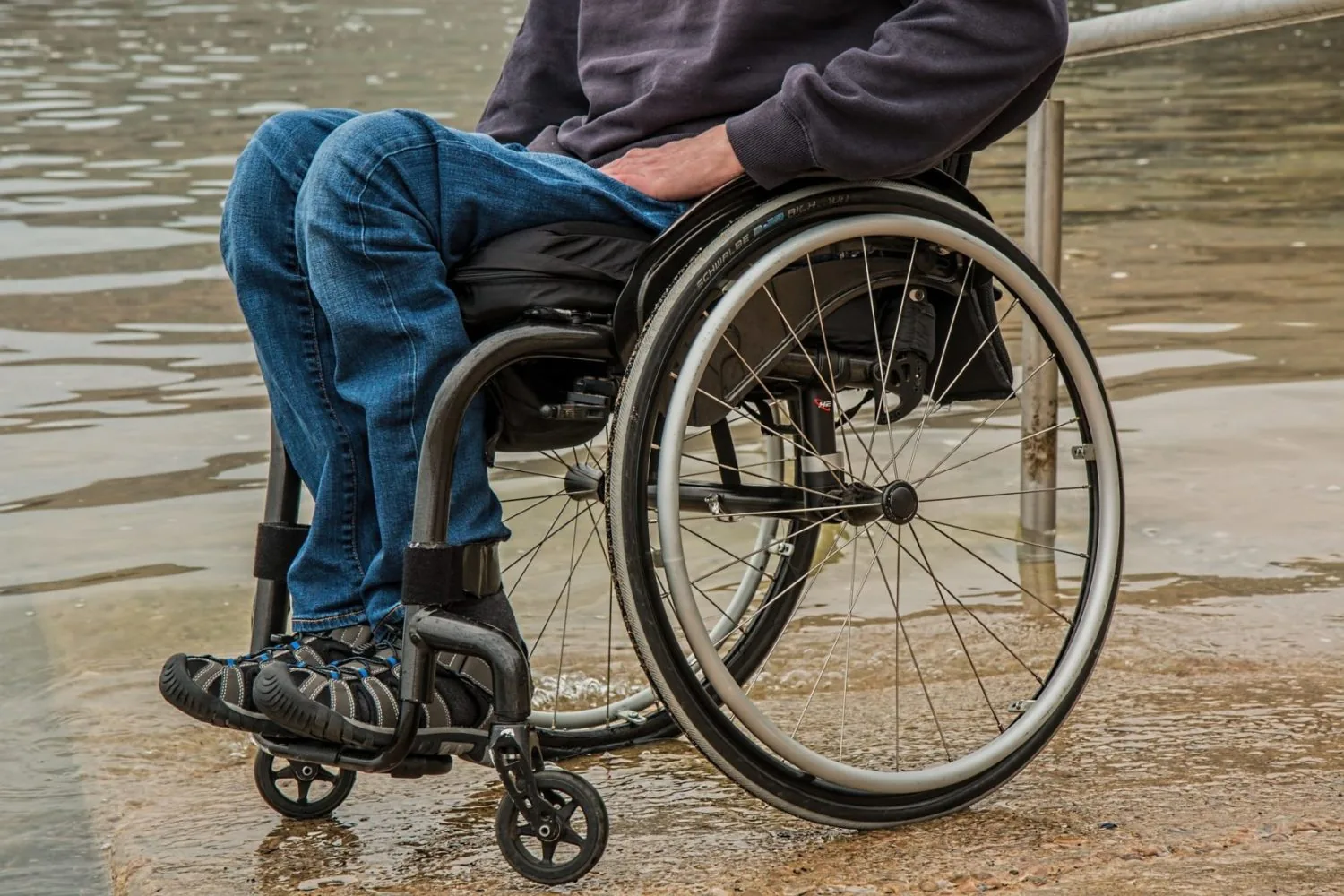 A wheelchair user beside a waterway