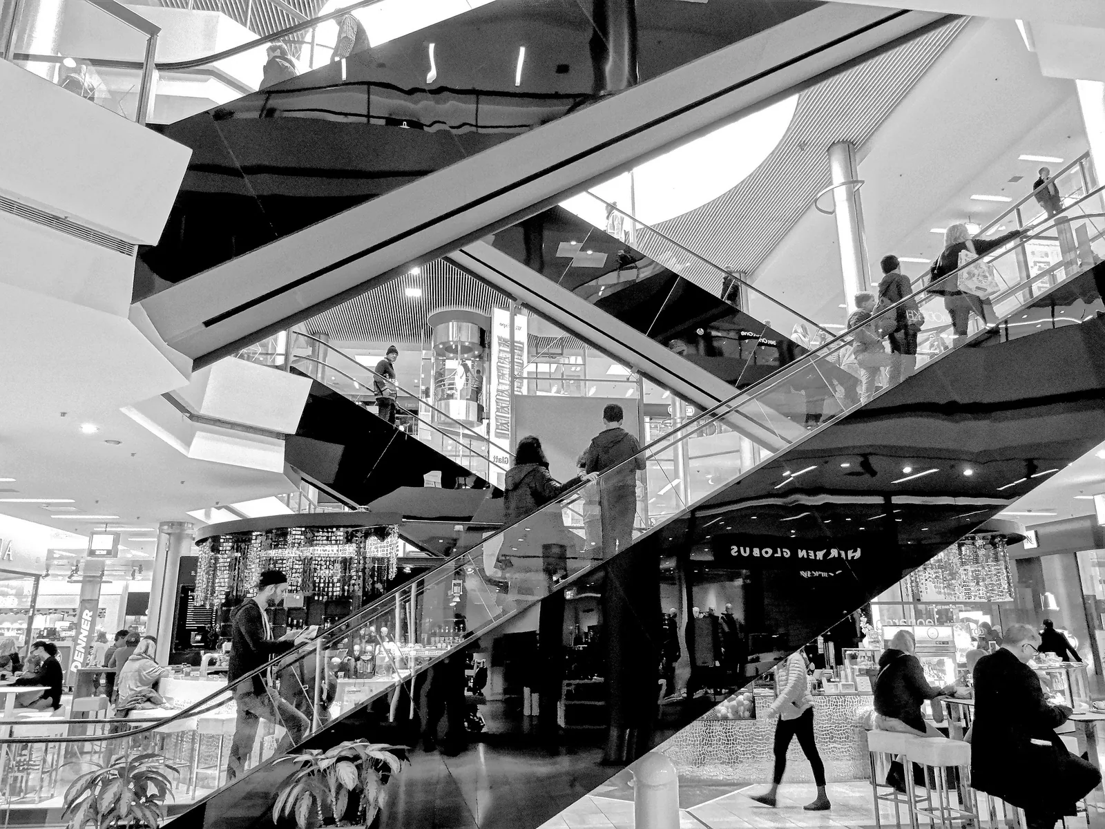 People travelling on escalators in a shopping centre