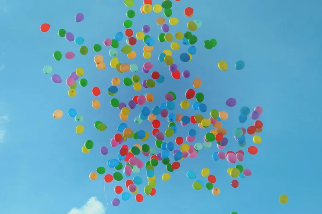 Colourful balloons against a blue sky