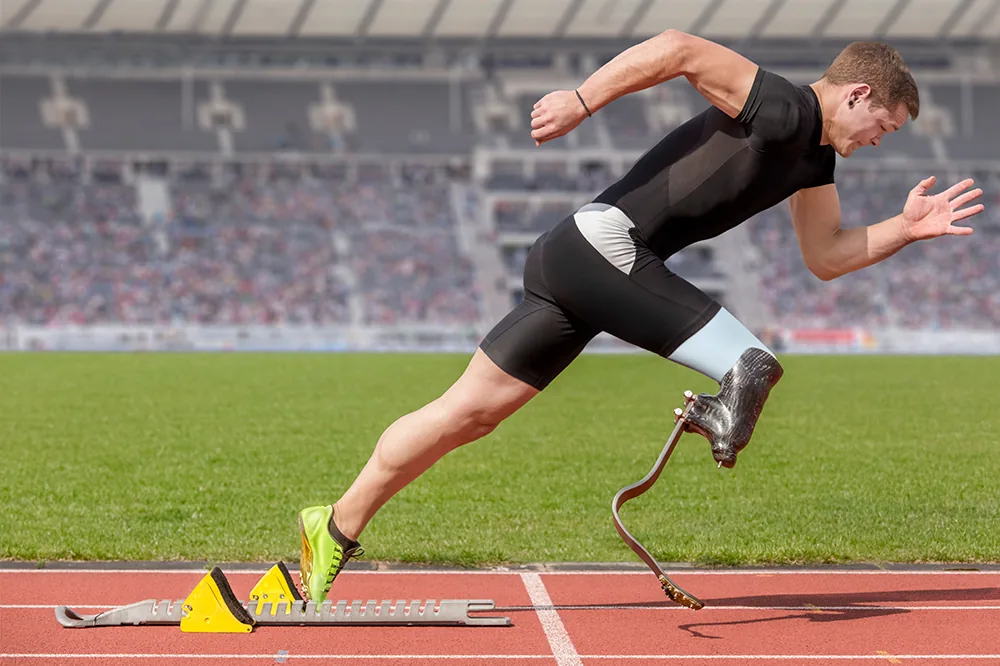 A runner using a blade prosthesis on an athletics track