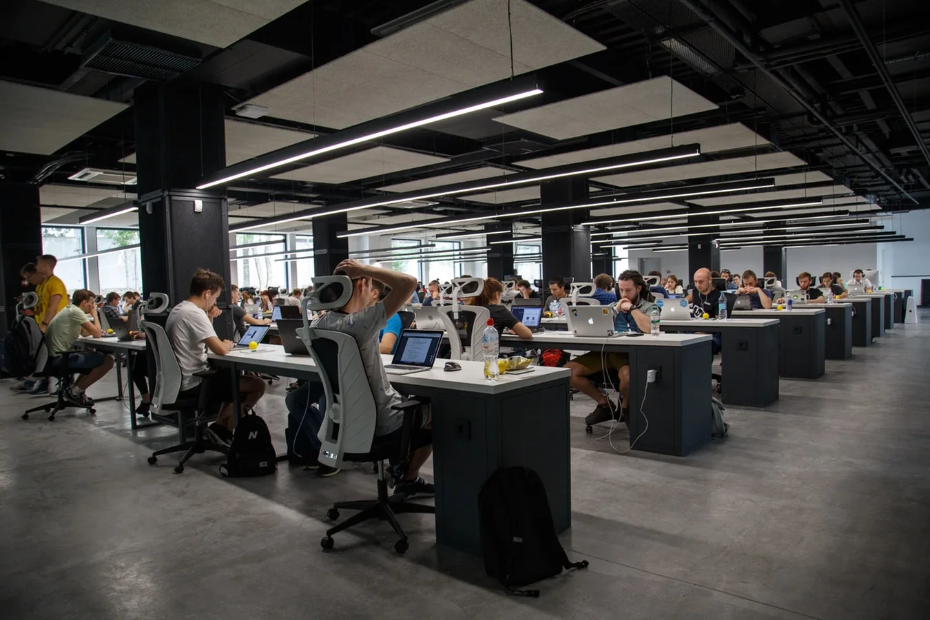 People working at desks in a large shared office