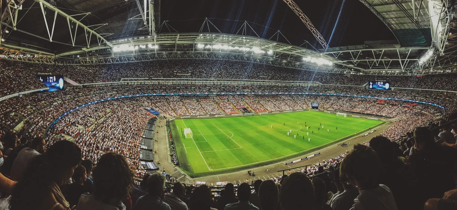 A crowded sports stadium viewed from the stands