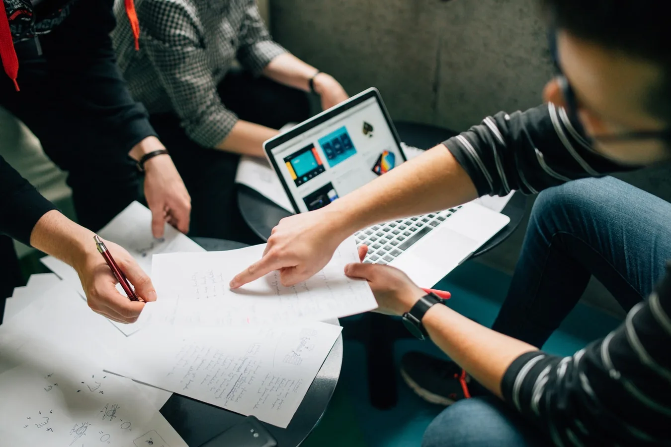 People discussing documents around a table