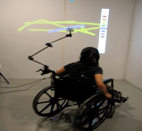 A wheelchair user interacting with a projected artwork