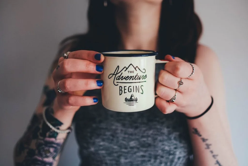 Coffee mug with 'adventure begins'