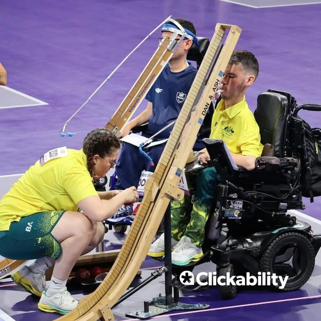A man in a powerchair setting up his boccia ramp for play.