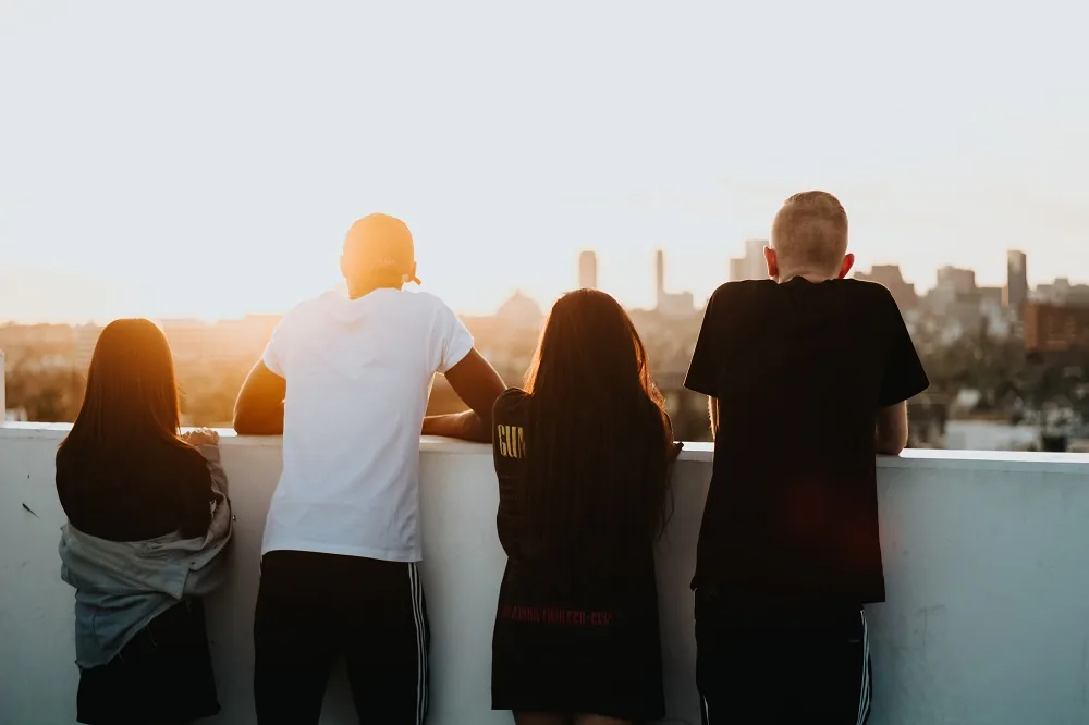 Four people looking towards a city skyline