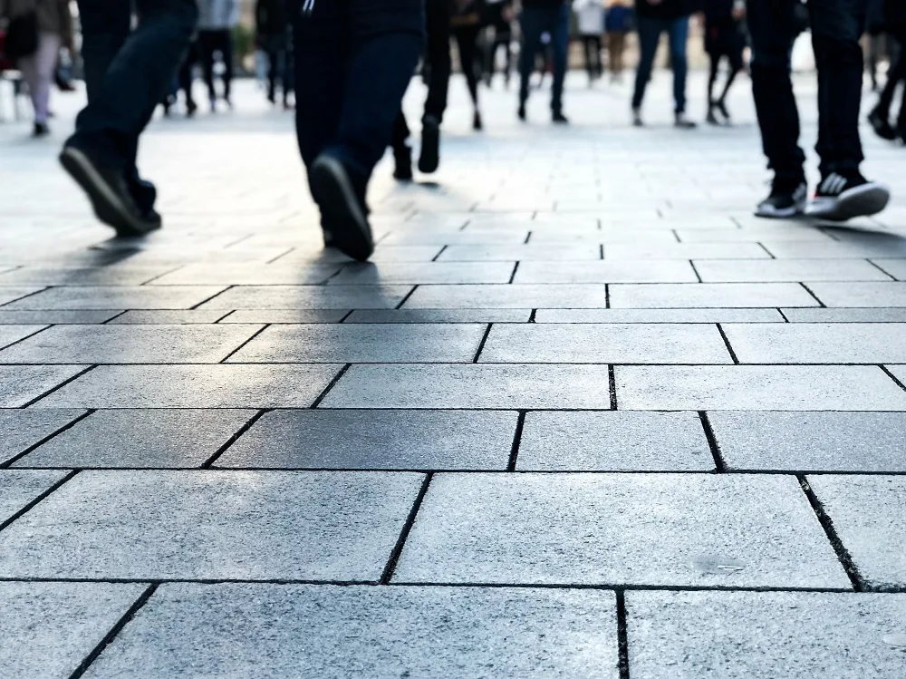 People walking along a paved city street