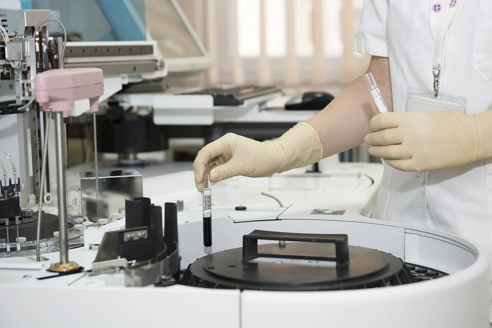 Gloved hands handling a sample in a laboratory