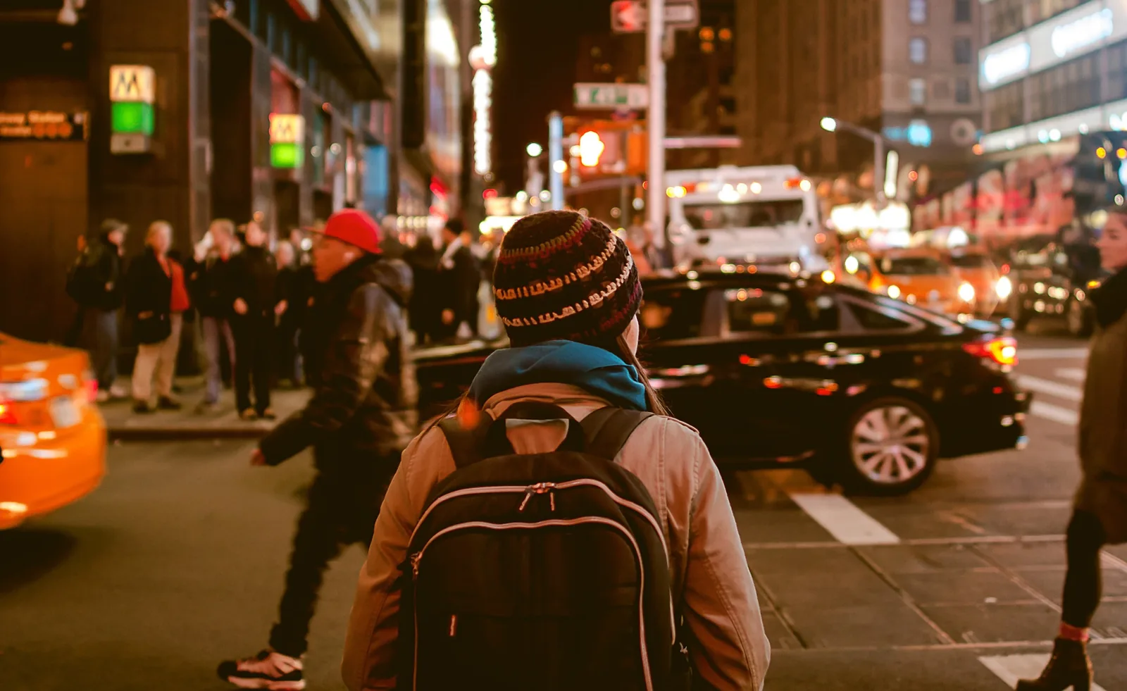 A person with a backpack on a busy city street