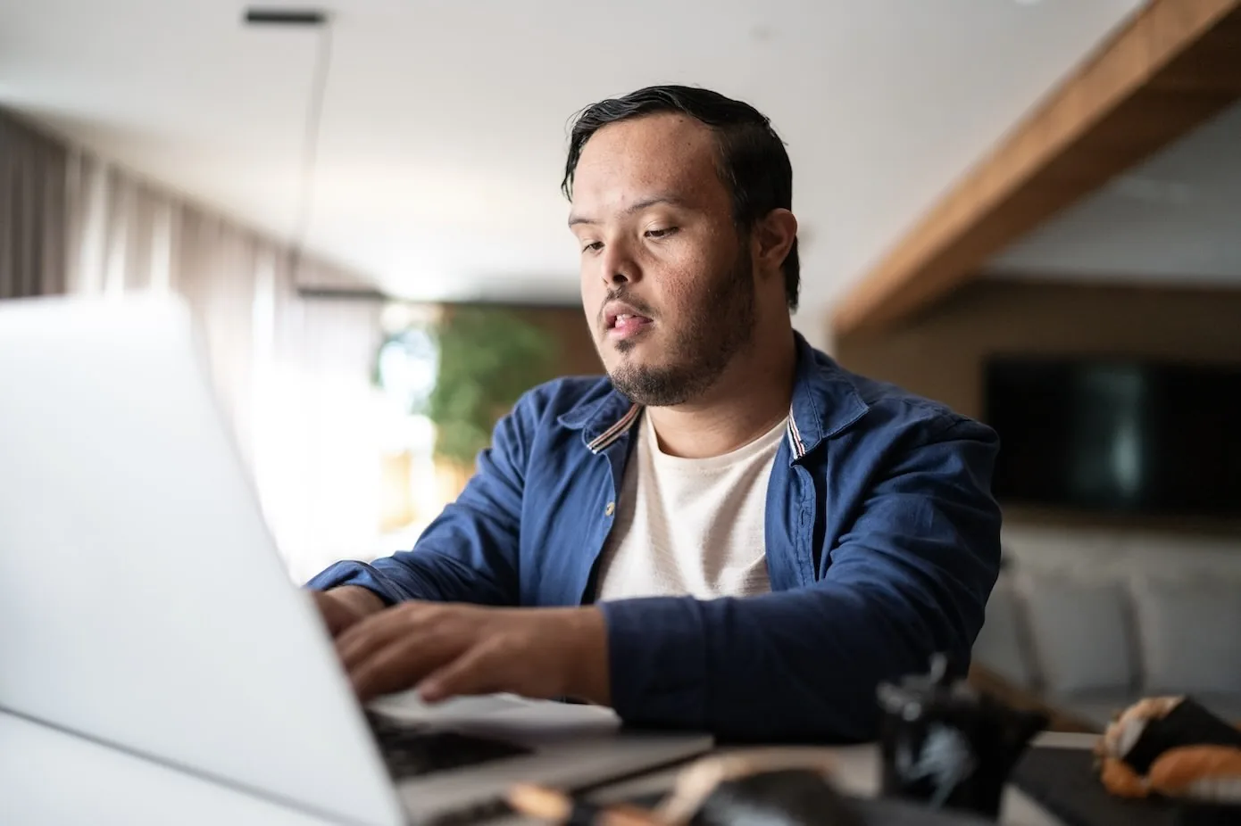 A person using a laptop at a table