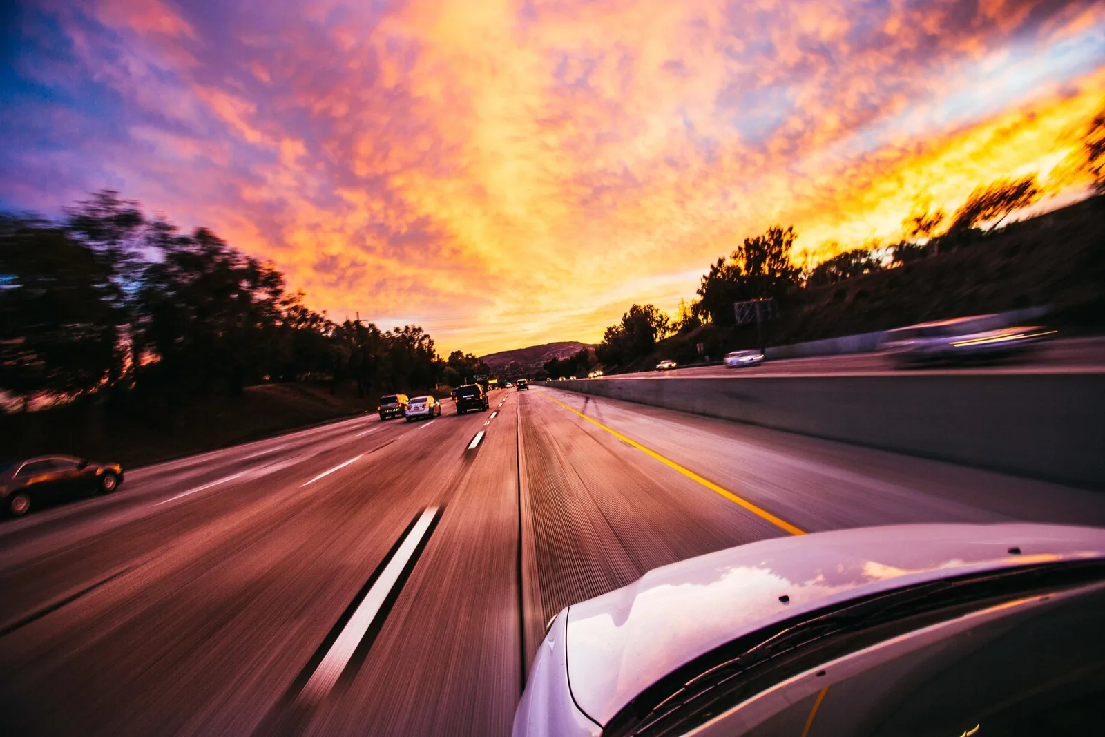 Road seen from a moving car at sunset