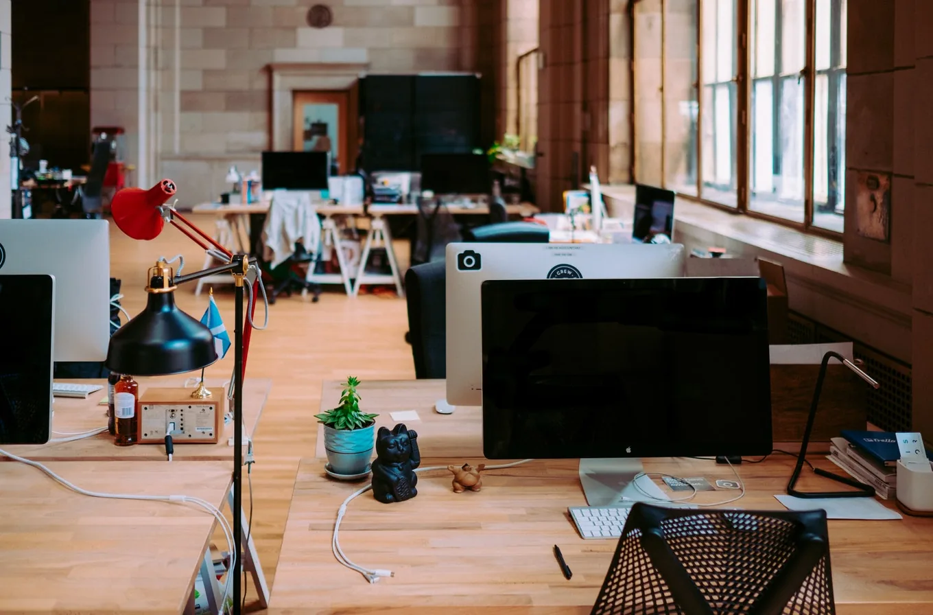 An office workspace with desks and computers