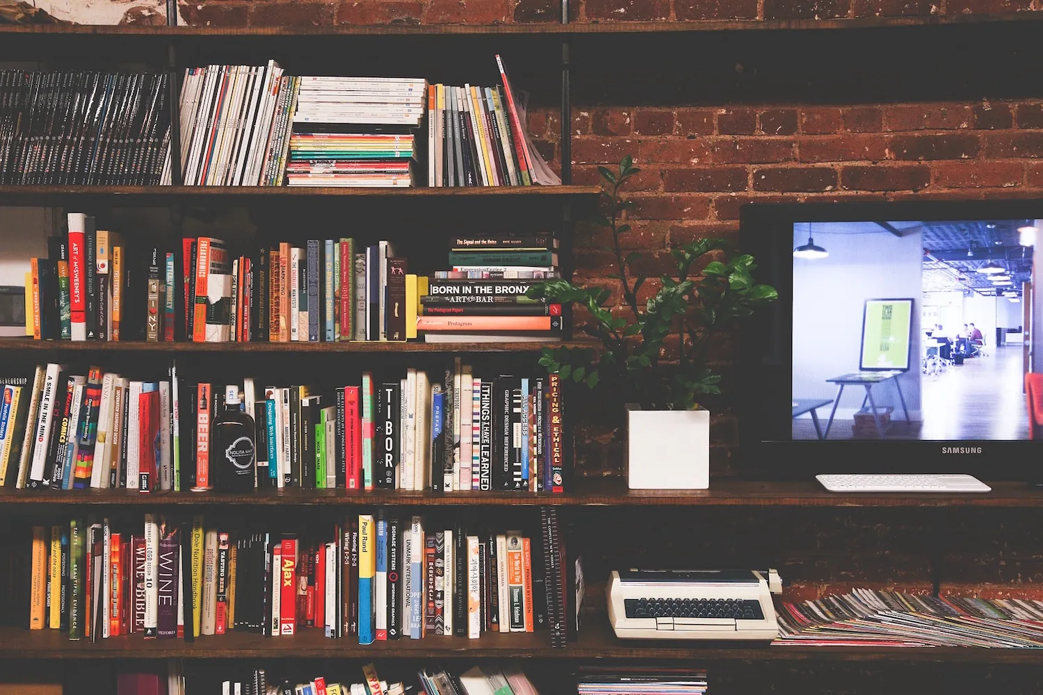 Bookshelves beside a computer screen