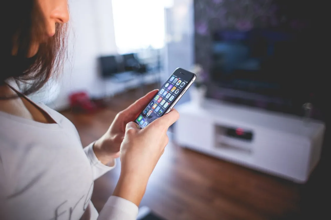 A person using a smartphone indoors