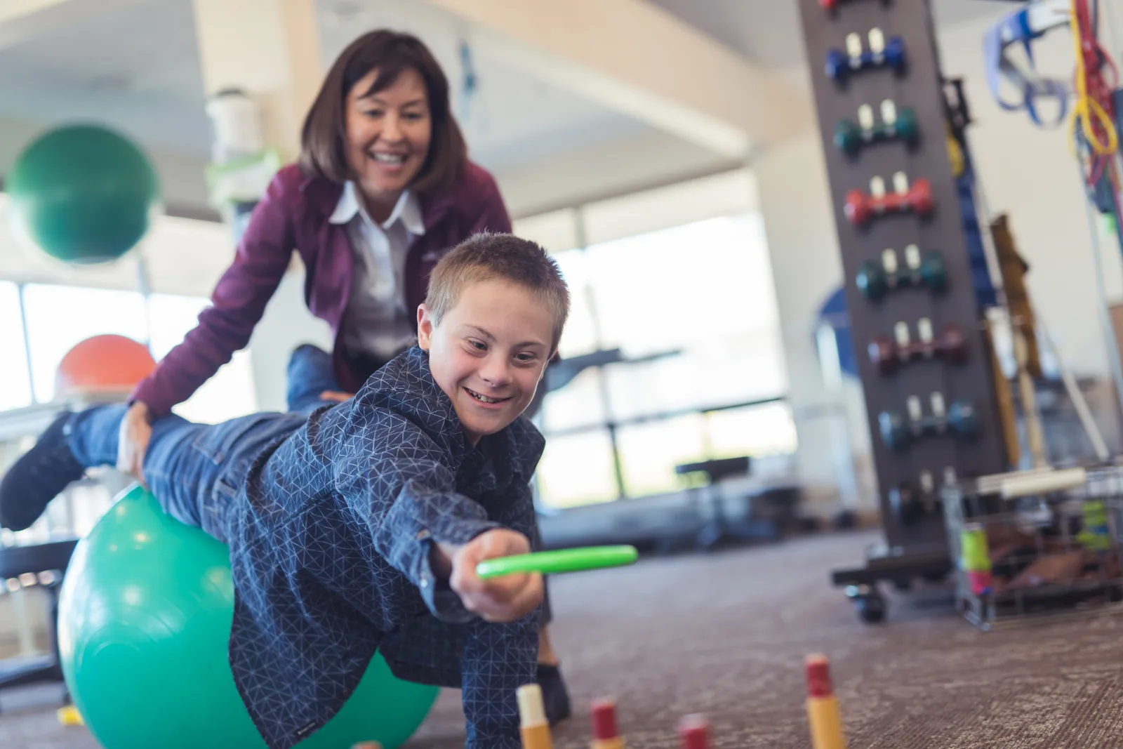 A person assisting another person with resistance-band activity