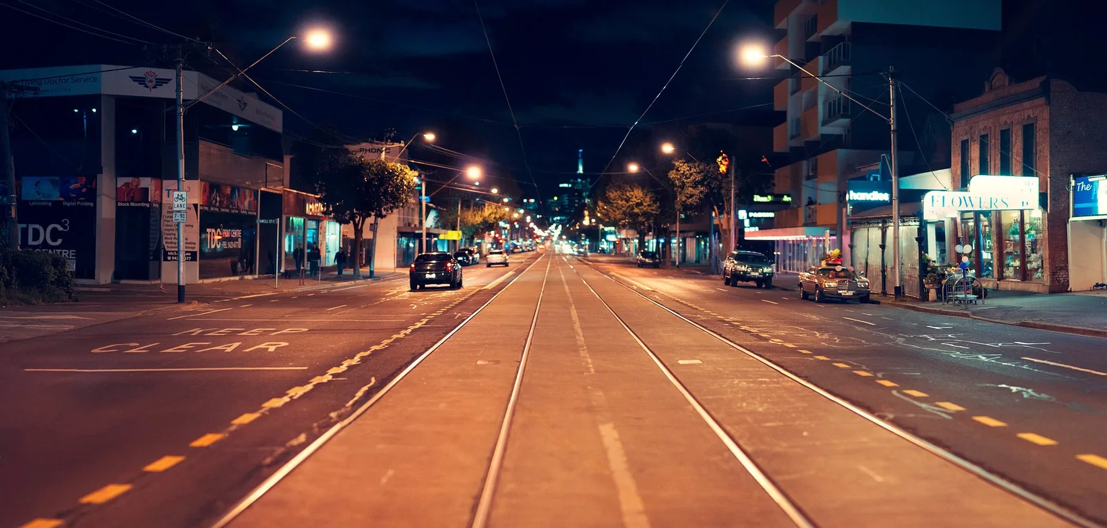 City street and tram tracks lit at night