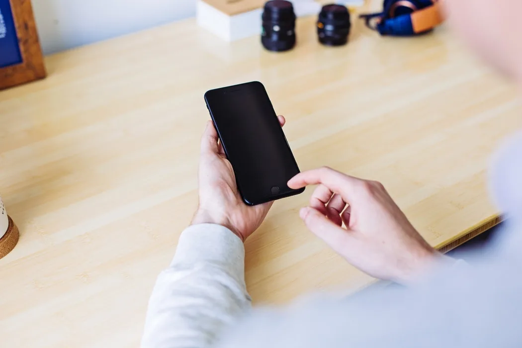 Hands holding and using a smartphone