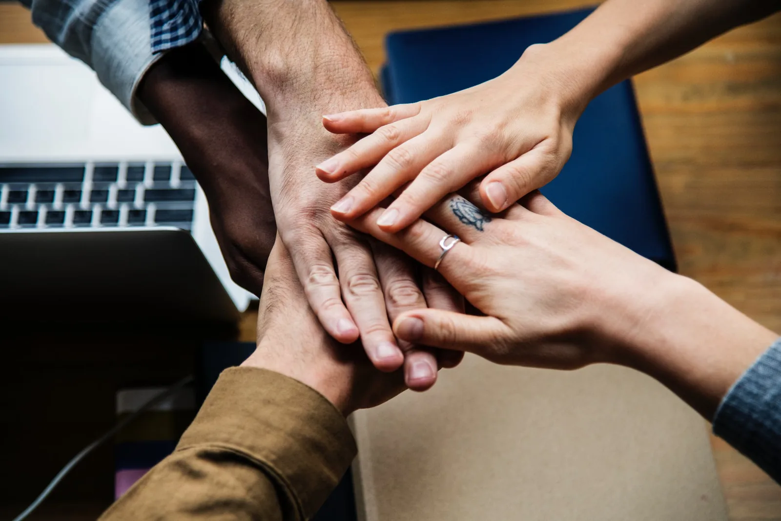 Several people placing their hands together