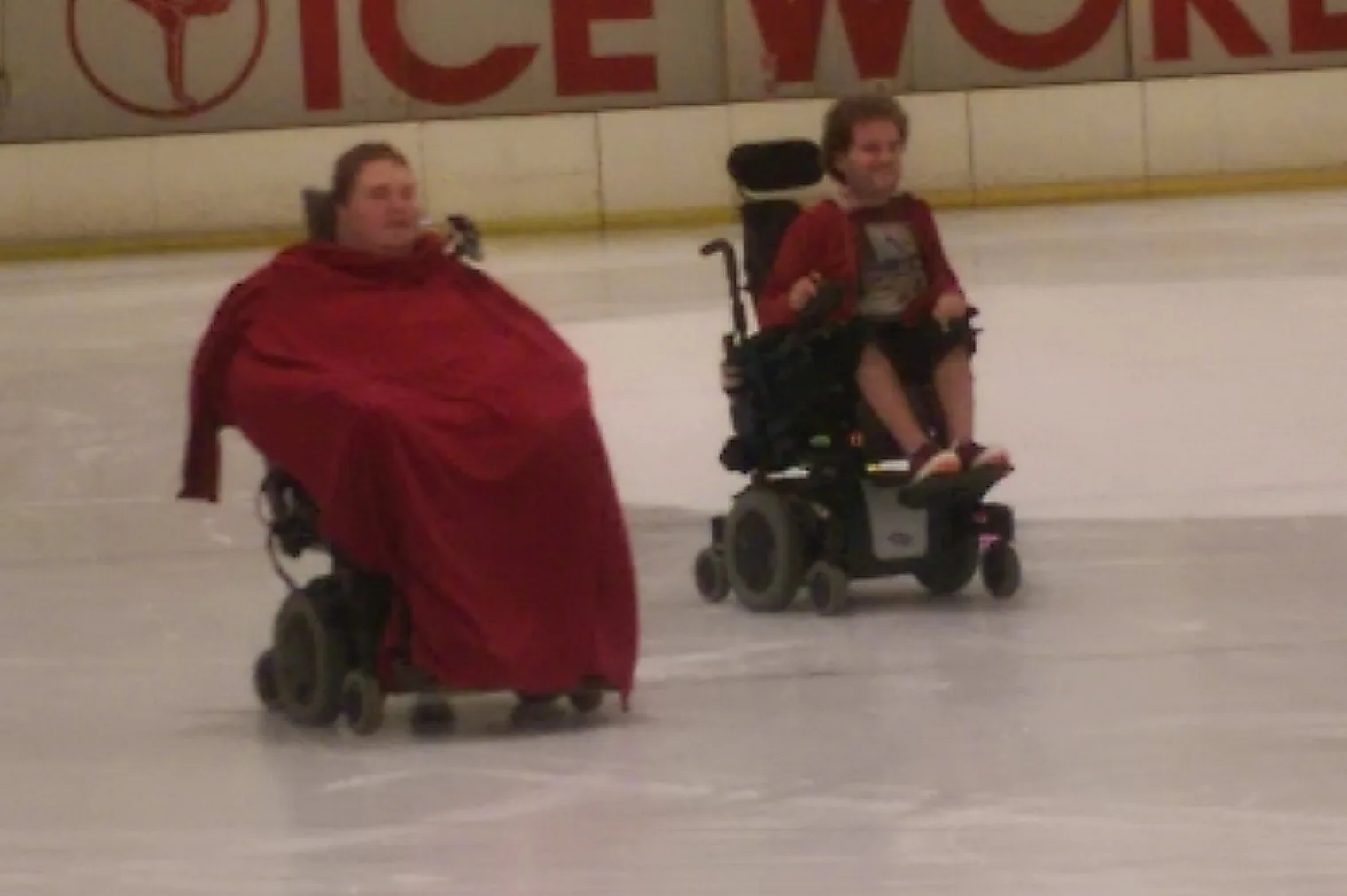 Two wheelchair users on an ice rink
