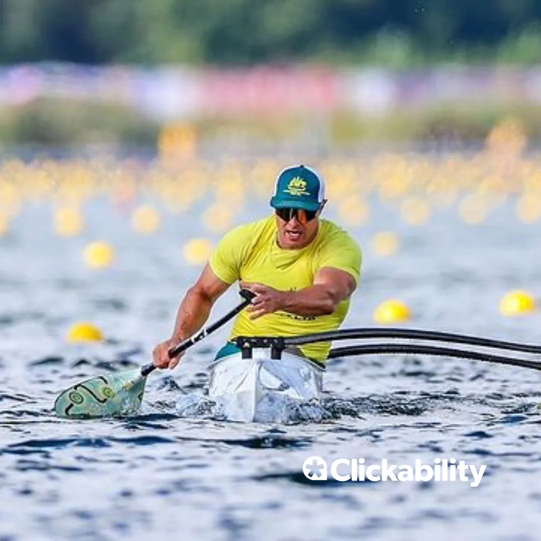 A man paddling in a canoe. 